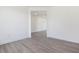A minimalist bedroom featuring white walls and luxury vinyl plank flooring at 150 Whimbrel Ct, Lillington, NC 27546