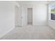 Bright bedroom featuring neutral carpet, natural light, and two closets at 150 Whimbrel Ct, Lillington, NC 27546