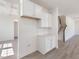 Butler's pantry with white cabinets, tile backsplash, and countertop space, near staircase at 150 Whimbrel Ct, Lillington, NC 27546