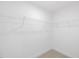 Walk-in closet featuring carpeted floors and custom storage shelves at 150 Whimbrel Ct, Lillington, NC 27546