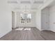 Dining room featuring coffered ceilings, luxury vinyl plank flooring, and a modern chandelier at 150 Whimbrel Ct, Lillington, NC 27546