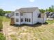 View of the back of the house highlighting the screened porch and spacious backyard at 150 Whimbrel Ct, Lillington, NC 27546