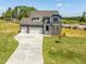 Beautiful two-story home featuring a two-car garage, stone accents and a well-manicured lawn at 150 Whimbrel Ct, Lillington, NC 27546