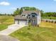 Charming two-story home with a stone facade, long driveway and manicured lawn at 150 Whimbrel Ct, Lillington, NC 27546