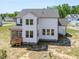 Exterior showing the rear of a white two-story home with a screened porch and ample windows at 150 Whimbrel Ct, Lillington, NC 27546