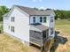 Back of home with a screen porch overlooking the backyard at 150 Whimbrel Ct, Lillington, NC 27546