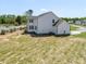 The rear of the home features a spacious yard with a covered patio, showcasing outdoor living at 150 Whimbrel Ct, Lillington, NC 27546