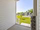 Covered front porch with stone pillars and an inviting view of the neighborhood at 150 Whimbrel Ct, Lillington, NC 27546