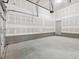 Spacious two-car garage with white walls and concrete floor at 150 Whimbrel Ct, Lillington, NC 27546