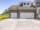 Spacious two car garage with a long driveway and exterior stone accents at 150 Whimbrel Ct, Lillington, NC 27546