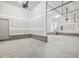 Three car garage featuring concrete floor, drywall, and stairs to the home at 150 Whimbrel Ct, Lillington, NC 27546