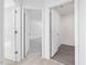 Hallway featuring white doors and carpeted floors at 150 Whimbrel Ct, Lillington, NC 27546