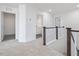 Upstairs hallway with wood railing and views of the bathrooms and bedrooms at 150 Whimbrel Ct, Lillington, NC 27546