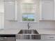 Modern kitchen featuring white cabinets, stainless steel appliances, and stainless sink at 150 Whimbrel Ct, Lillington, NC 27546