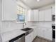 Modern kitchen features white cabinets, stainless steel appliances, and subway tile backsplash at 150 Whimbrel Ct, Lillington, NC 27546