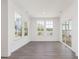 Bright and airy room features three large windows and a glass door that lead to an outdoor deck at 150 Whimbrel Ct, Lillington, NC 27546