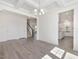 Open concept living room featuring luxury vinyl plank flooring and coffered ceiling at 150 Whimbrel Ct, Lillington, NC 27546