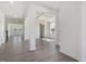Open-concept living room with coffered ceiling, gray luxury vinyl plank flooring, and large windows at 150 Whimbrel Ct, Lillington, NC 27546