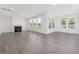 Spacious living room featuring a fireplace and plenty of natural light from several windows at 150 Whimbrel Ct, Lillington, NC 27546