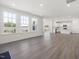 Open concept living space with bright white kitchen featuring stainless steel appliances at 150 Whimbrel Ct, Lillington, NC 27546
