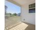Covered porch with a wood deck, overlooking a lawn and neighboring house at 150 Whimbrel Ct, Lillington, NC 27546