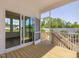 Covered porch features wood deck, leads indoors via sliding glass door, and features fenced-in backyard views at 150 Whimbrel Ct, Lillington, NC 27546