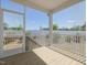 Screened-in porch with a wood deck that looks out onto a fenced in yard at 150 Whimbrel Ct, Lillington, NC 27546