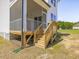 View of the screened porch with steps leading down to the backyard at 150 Whimbrel Ct, Lillington, NC 27546