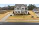 An aerial view showcasing the home's location near a serene pond and expansive lawn at 254 Dungannon, Clayton, NC 27520