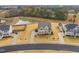 Aerial view of the home with surrounding landscape, pond, and neighborhood streets at 254 Dungannon, Clayton, NC 27520
