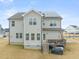 Home's back exterior featuring solar panels, deck, and expansive backyard at 254 Dungannon, Clayton, NC 27520