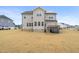 Backyard view of the home, showcasing the deck, patio, lawn, and solar panels at 254 Dungannon, Clayton, NC 27520