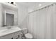 Bright bathroom with white vanity, neutral countertop, and shower with white curtain at 254 Dungannon, Clayton, NC 27520