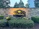Elegant stone entrance sign for 'Wellesley' community surrounded by lush green bushes and landscaping at 254 Dungannon, Clayton, NC 27520