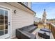 Relaxing outdoor wooden deck featuring modern seating and a table with an umbrella at 254 Dungannon, Clayton, NC 27520