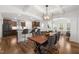 Open-concept kitchen and dining area with modern bar stools, coffered ceilings, and stylish decor at 254 Dungannon, Clayton, NC 27520