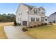 Two-story home showcasing manicured lawn, paved driveway, and neutral-toned facade at 254 Dungannon, Clayton, NC 27520