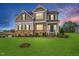 Beautiful two-story home with stone accents, a well-manicured lawn, and a welcoming front porch at 254 Dungannon, Clayton, NC 27520