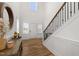 Bright foyer featuring hardwood floors, a staircase with dark iron balusters, and natural light at 254 Dungannon, Clayton, NC 27520