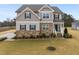 Charming two-story home with a stone and siding exterior and landscaped front yard at 254 Dungannon, Clayton, NC 27520