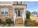 A welcoming front porch with stone steps and white railing, complementing the home's exterior at 254 Dungannon, Clayton, NC 27520