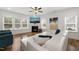 Sunlit living room featuring a fireplace, modern white sofa, and stylish decor at 254 Dungannon, Clayton, NC 27520