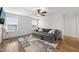 Inviting living room featuring a comfortable sectional sofa, area rug, and natural light from the windows at 254 Dungannon, Clayton, NC 27520