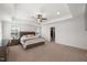 Bright main bedroom showcasing a king-sized bed, tray ceilings, and walk-in closet at 254 Dungannon, Clayton, NC 27520