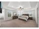 Spacious main bedroom with tray ceiling, ample natural light, and a stylish dresser and nightstands at 254 Dungannon, Clayton, NC 27520