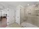 Modern shower with tiled walls, glass enclosure, bench, and modern fixtures at 254 Dungannon, Clayton, NC 27520