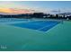 Well-maintained community tennis courts featuring vibrant blue and green surfaces and enclosed by a chain-link fence at 254 Dungannon, Clayton, NC 27520