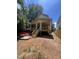New construction back porch with wooden stairs, railings, and support beams overlooking an unfinished backyard at 3302 Hall Pl, Raleigh, NC 27607
