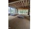 Interior view of a room under construction with exposed beams, large windows and sliding glass doors at 3302 Hall Pl, Raleigh, NC 27607