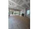 Unfinished living room with fireplace, large windows, trimwork, and sliding glass door access to the back deck at 3302 Hall Pl, Raleigh, NC 27607